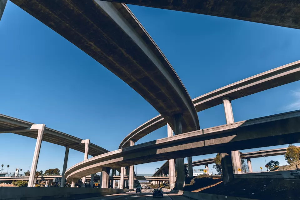 View from under tall Los Angeles freeway overpass.